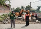 Pembongkaran Paving Jalan Desa Slempit Dimulai, TMMD 128 Kodim 0817/Gresik Siapkan Pengaspalan